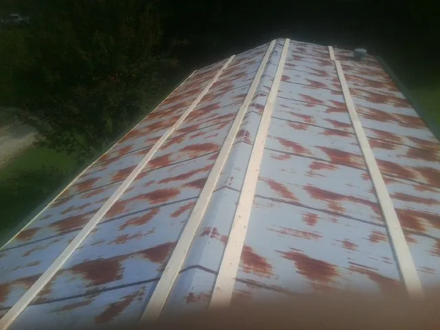 Rusted metal roof panels with new wood purlins before replacement — Storm Damage Roof Repair in Lake Worth by Roofing Brothers