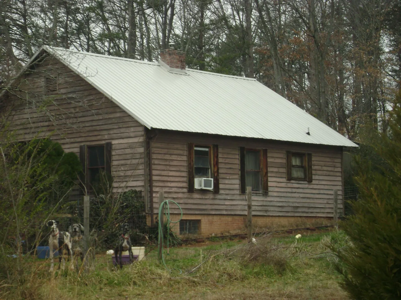 White metal roof on an old wood sided farmhouse, from a Metal Roof Installation job in Lake Worth